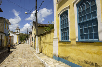 Empty alley amidst buildings in town