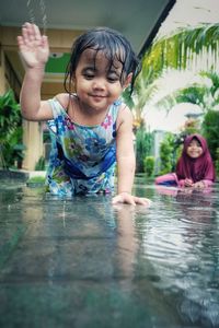 Portrait of happy girl in swimming pool