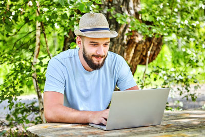 Midsection of man using mobile phone