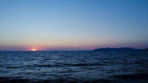 Scenic view of sea against clear sky during sunset