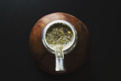 High angle view of drink on table against black background