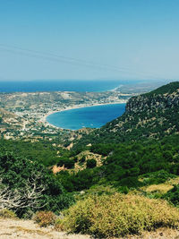 Scenic view of bay against clear blue sky