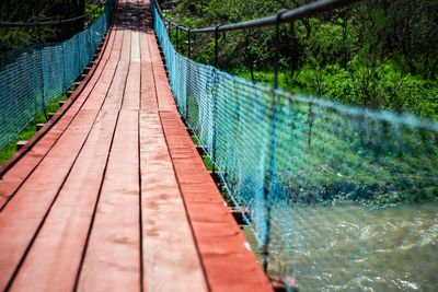 Footbridge over river in forest