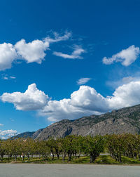 Scenic view of mountains against blue sky