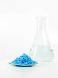 Close-up of drink on table against white background