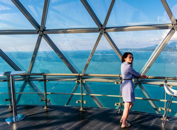 Rear view of young woman standing at observation point