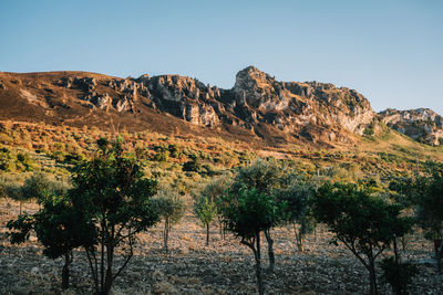 Rock formations on mountain against clear sky