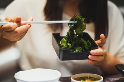 Midsection of woman holding food