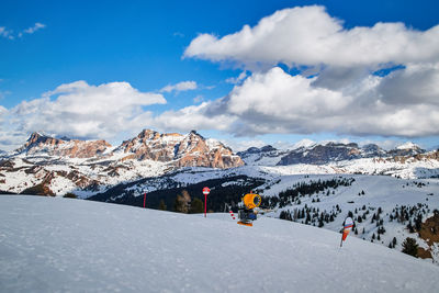 Yellow snow cannon on the snowy red slope called campolongo on the sella ronda ski tour