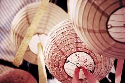 Low angle view of clock hanging on wood