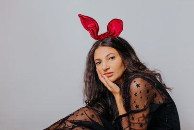 Portrait of a beautiful young woman against white background