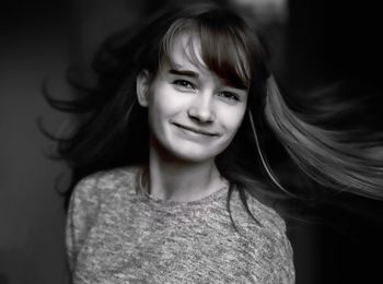 Portrait of smiling teenage girl tossing hair