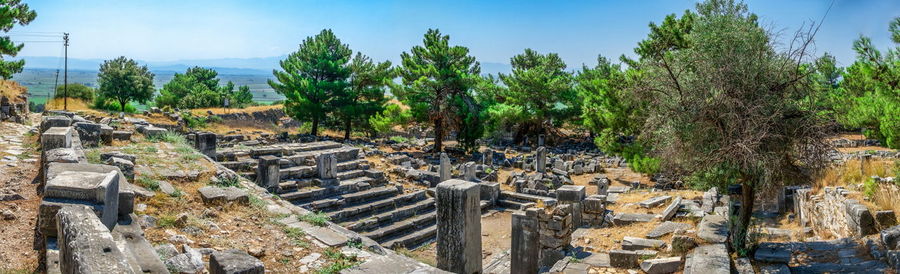 Panoramic view of old ruin in forest against sky