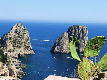 High angle view of rock formation in sea against clear sky