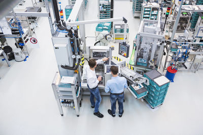 Two men talking in factory shop floor