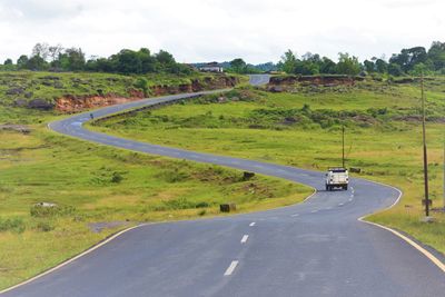 Road passing through landscape against sky