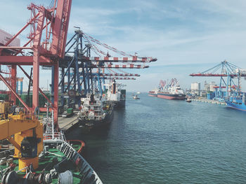 Commercial dock by sea against sky