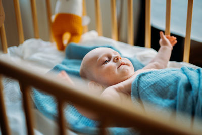 Cute baby lying in crib