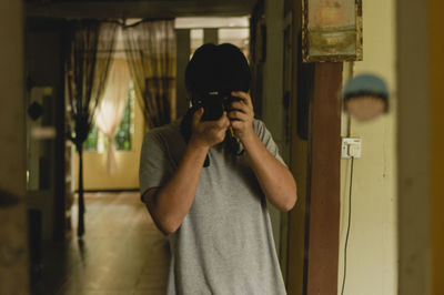 Full length of young man photographing