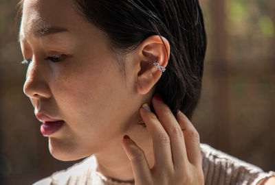 Close-up of young woman looking away