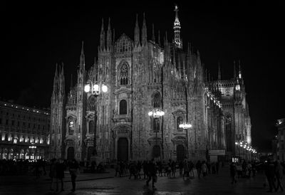 Group of people in front of building at night