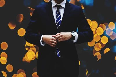 Midsection of man holding umbrella