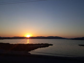 Scenic view of sea against clear sky during sunset