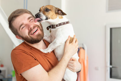 Portrait of smiling young woman with dog