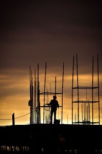 Silhouette man standing against sky during sunset