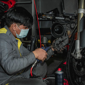 Side view of man working at workshop