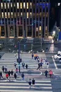 Group of people walking on street at night