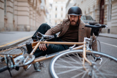 Rear view of man riding bicycle on street