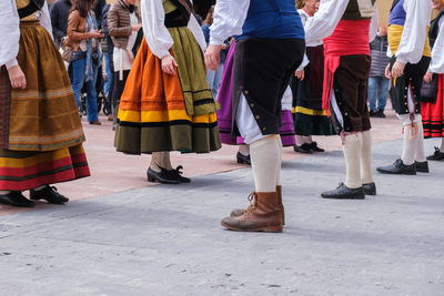 Low section of people walking on street