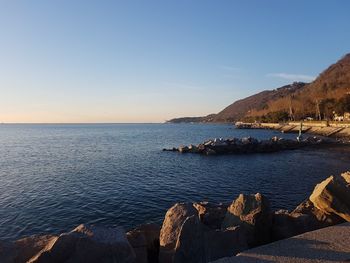 Scenic view of sea against clear sky during sunset