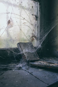 Damaged window in abandoned building