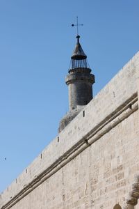 Low angle view of lighthouse against clear blue sky