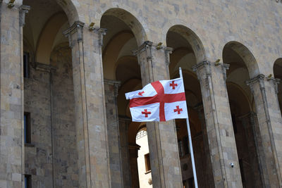 Low angle view of flags on old building