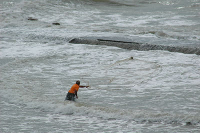 Fisherman fishing in sea