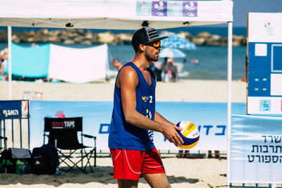 Full length of young man standing on beach