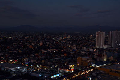 High angle view of illuminated city buildings at dusk