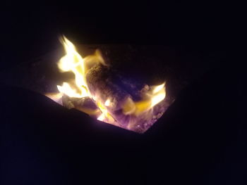 Close-up of fire against sky at night