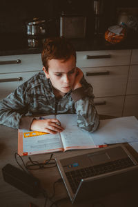 Boy taking online lessons for school