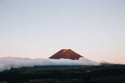 Scenic view of volcanic landscape against clear sky during sunset