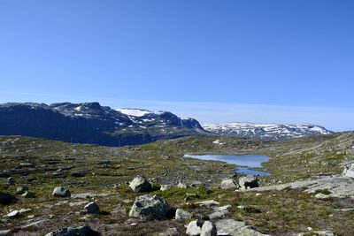 Scenic view of mountains against clear blue sky