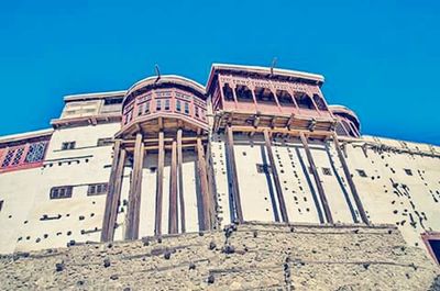 Low angle view of building against clear blue sky