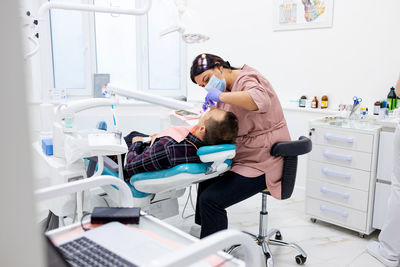 High angle view of dentist working in clinic