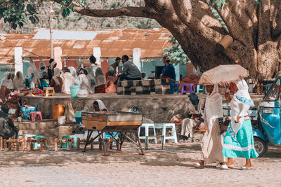 Group of people sitting on chair in city