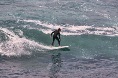 Full length of man surfing in sea