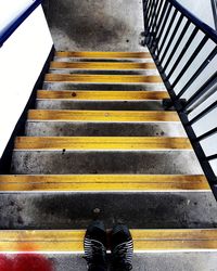 Low section of person standing on staircase