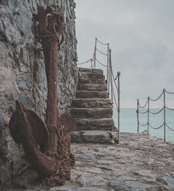 Staircase on beach against sky